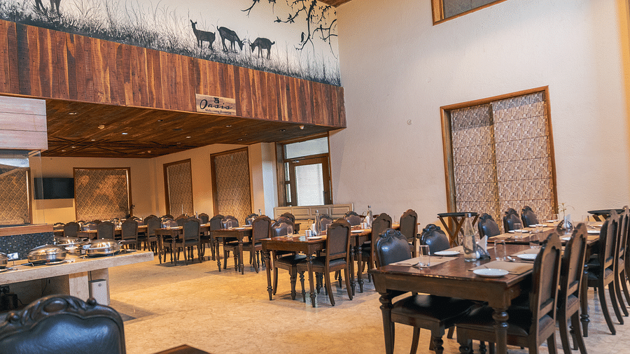 Oasis Restaurant dining area with tables and chairs arranged and a buffet counter on the side